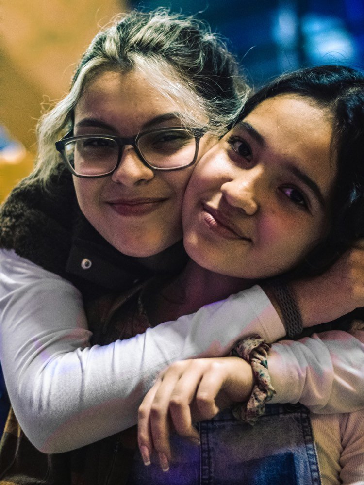 Two friends with their arms around each other