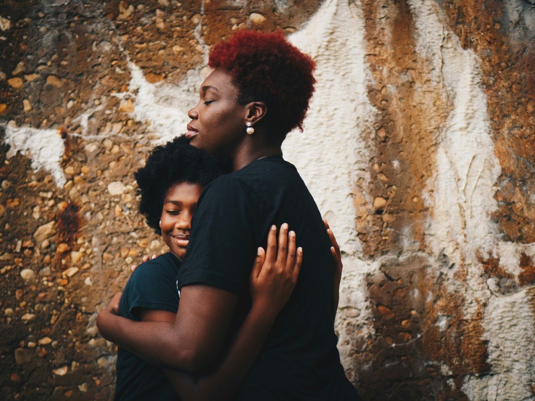 Two women holding each other close