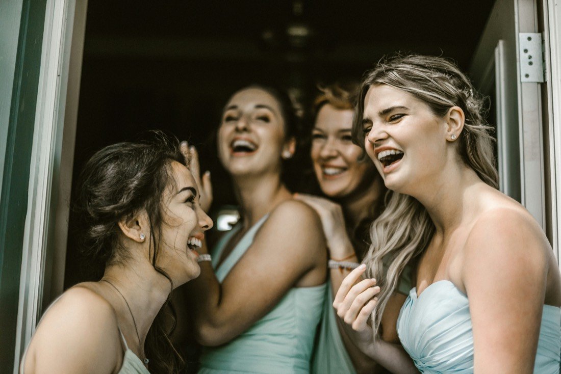 Four women laughing together